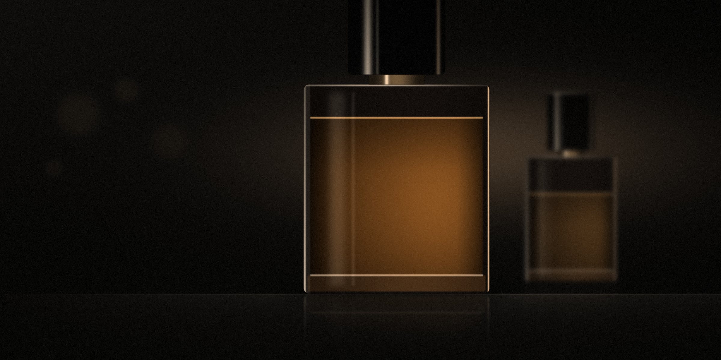 Unbranded fragrance flacons in low light, amber glass on dark stone